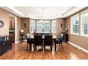 Formal dining room featuring hardwood floors, large windows, and a stylish chandelier at 6803 Esmeralda Dr, Castle Rock, CO 80108