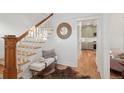 Entryway with wooden staircase and view of kitchen at 1086 S Pearl St, Denver, CO 80209