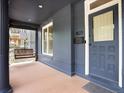 Inviting front porch with classic columns, a cozy swing, and a charming entryway for a warm welcome at 1423 Elizabeth St, Denver, CO 80206