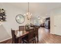 Bright dining area with hardwood floors and a chandelier at 8767 E Dry Creek Rd # 1312, Englewood, CO 80112