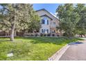 Two-story townhome with landscaped grounds and a brick facade at 8767 E Dry Creek Rd # 1312, Englewood, CO 80112