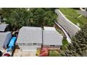 Aerial view of the split-level home showcases roof, yard and proximity to neighborhood street at 8595 Field Ct, Arvada, CO 80005