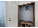 Entryway features a built-in bench with hooks and storage baskets, offering a practical and organized space at 11081 Cannonade Dr, Parker, CO 80138