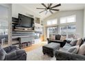 Inviting living room featuring a modern fireplace, large screen television, and comfortable seating at 11081 Cannonade Dr, Parker, CO 80138