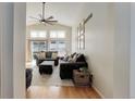 Bright living room with high ceilings, large windows, and a cozy seating arrangement, perfect for relaxation at 11081 Cannonade Dr, Parker, CO 80138
