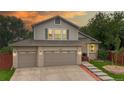 Charming two-story home featuring a well-manicured lawn and a spacious three-car garage at 10517 Clermont Way, Thornton, CO 80233