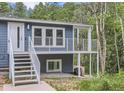 Home with a blue exterior, surrounded by a lush, green forest at 629 Copperdale Ln, Golden, CO 80401
