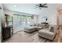 A living room with an L-shaped sofa, wood floors, and big bright windows at 629 Copperdale Ln, Golden, CO 80401