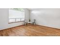 Bright, open bedroom space with natural light from a window and hardwood floors at 9036 W Wisconsin Ave, Lakewood, CO 80232