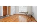 Bright bedroom featuring natural light and hardwood floors with a view of two doors in the background at 9036 W Wisconsin Ave, Lakewood, CO 80232