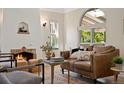 Cozy living room with a fireplace, comfortable seating, and a large window at 1434 Clermont St, Denver, CO 80220