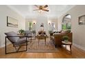Bright living room featuring a decorative fireplace, hardwood floors and stylish furnishings at 1434 Clermont St, Denver, CO 80220