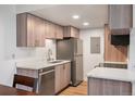 Modern kitchen featuring stainless steel appliances, wood cabinets, and marble countertops at 8225 Fairmount Dr # 10-204, Denver, CO 80247