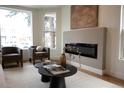 Cozy living room featuring modern fireplace, neutral color palette, and elegant furnishings at 2831 N Perry St, Denver, CO 80212