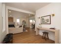 Spacious open floor plan showcases living room with contemporary fireplace and gleaming hardwood floors at 2831 N Perry St, Denver, CO 80212