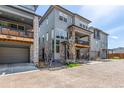 Street view showcasing modern two-story homes with stone accents, balconies, drive-under garages, and well-kept landscaping at 15774 W Girard Ave, Morrison, CO 80465