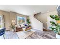 Inviting living room features wood floors, neutral walls, large windows, and stylish decor at 1933 Villageview Ln, Castle Rock, CO 80104