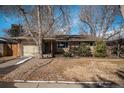 Charming single-story home with an attached garage and beautifully maintained front yard at 3083 S Xanthia St, Denver, CO 80231