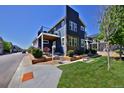 Modern two-story home features a combination of blue siding and stone accents and a balcony at 719 Robert St, Longmont, CO 80503