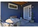 Charming front porch seating area with a stylish table and chairs, and a well kept front door at 719 Robert St, Longmont, CO 80503