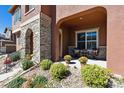 Stone porch with seating area and autumn decor at 10654 Ashfield St, Highlands Ranch, CO 80126