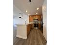 Modern kitchen with stainless steel appliances, wooden cabinets, and a stylish island for meal preparation at 15955 E Geddes Dr # 55, Aurora, CO 80016