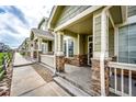 Inviting front porches with stone accents, providing a charming welcome to the townhomes at 15955 E Geddes Dr # 55, Aurora, CO 80016