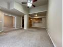 Inviting living room with neutral carpet, open layout, and a bar area, perfect for entertaining and relaxation at 4519 S Atchison Way, Aurora, CO 80015