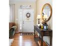 Bright foyer with hardwood floors, decorative mirror, and an abundance of natural light at 1410 Exquisite St, Castle Rock, CO 80109