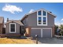 Charming two-story home featuring a two-car garage and striking window design at 11404 E Yale Pl, Aurora, CO 80014