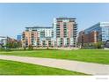 Modern brick apartment building with green space and sidewalks at 1401 Wewatta St # 714, Denver, CO 80202