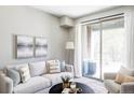 Sun-filled living room with neutral palette, balcony access, and comfortable, modern seating at 5036 S Platte River Pkwy, Littleton, CO 80123