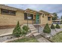 Inviting front exterior with a well-manicured yard and a charming turquoise door at 10600 E 25Th Ave, Aurora, CO 80010