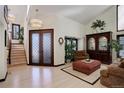 Bright foyer featuring double doors, hardwood floors, and a staircase, creating an open feel at 9526 E Lake Ave, Greenwood Village, CO 80111