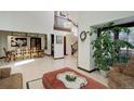 Open-concept living room with hardwood floors, high ceilings, and a view into the dining area at 9526 E Lake Ave, Greenwood Village, CO 80111
