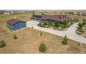 Sprawling property with a well-manicured lawn, outbuilding, and a long driveway leading to a charming two-story home at 3967 Eastout Ave, Parker, CO 80138
