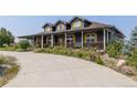 Attractive two-story home with a covered porch, complemented by a well-maintained driveway and landscaping at 3967 Eastout Ave, Parker, CO 80138