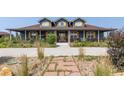 Charming two-story home with a welcoming porch and landscaped front yard at 3967 Eastout Ave, Parker, CO 80138