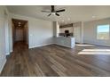 Open-concept living room featuring wood floors, recessed lighting, and an island with modern finishes at 48245 Shetland Dr, Bennett, CO 80102