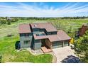 A stunning aerial view of this two-story home with a well-manicured lawn in a lush green neighborhood at 6388 Donner Cir, Parker, CO 80134