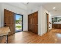 Inviting entryway with hardwood floors, a closet, and a view into the kitchen and out to the front yard at 6388 Donner Cir, Parker, CO 80134