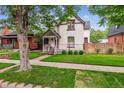 Charming home with a welcoming front porch and well-maintained lawn at 912 S Washington St, Denver, CO 80209