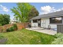 Well-maintained backyard featuring a patio, grill, wooden fence, and lush greenery at 8867 Yukon St # 49, Broomfield, CO 80021