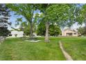 Scenic community park with picnic tables, mature trees, and walking path among the neighborhood homes at 8867 Yukon St # 49, Broomfield, CO 80021