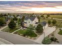 Panoramic aerial shot displays a gray two-story home with a well-kept lawn, mature trees, and surrounding neighborhood at 5397 Lenox Ct, Castle Rock, CO 80104