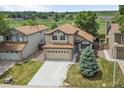 Aerial view of a two-story home featuring a well-maintained yard and two car garage at 9669 Jellison Way, Broomfield, CO 80021