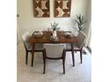 Inviting dining room with mid-century modern table set for four, with bright neutral decor at 8625 W Dartmouth Pl, Lakewood, CO 80227