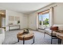 Cozy living room with a bay window, neutral tones, and comfortable seating at 8625 W Dartmouth Pl, Lakewood, CO 80227