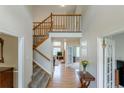 Inviting foyer with hardwood floors, staircase, and views of the living area at 14261 W Evans Cir, Lakewood, CO 80228