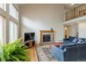Bright living room with a fireplace, hardwood floors, and large windows at 14261 W Evans Cir, Lakewood, CO 80228
